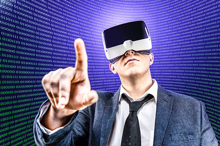 Businessman in a VR headset pointing upwards against a wall of binary code