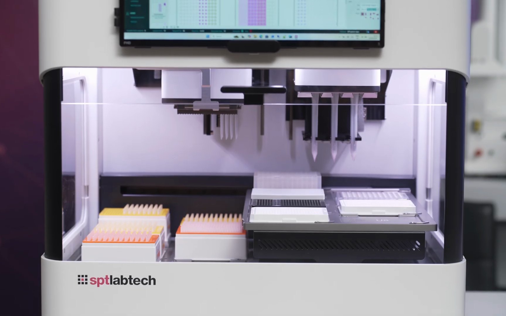 The real instrument, filmed by SPT Labtech: both heads above a deck of plates and tip boxes