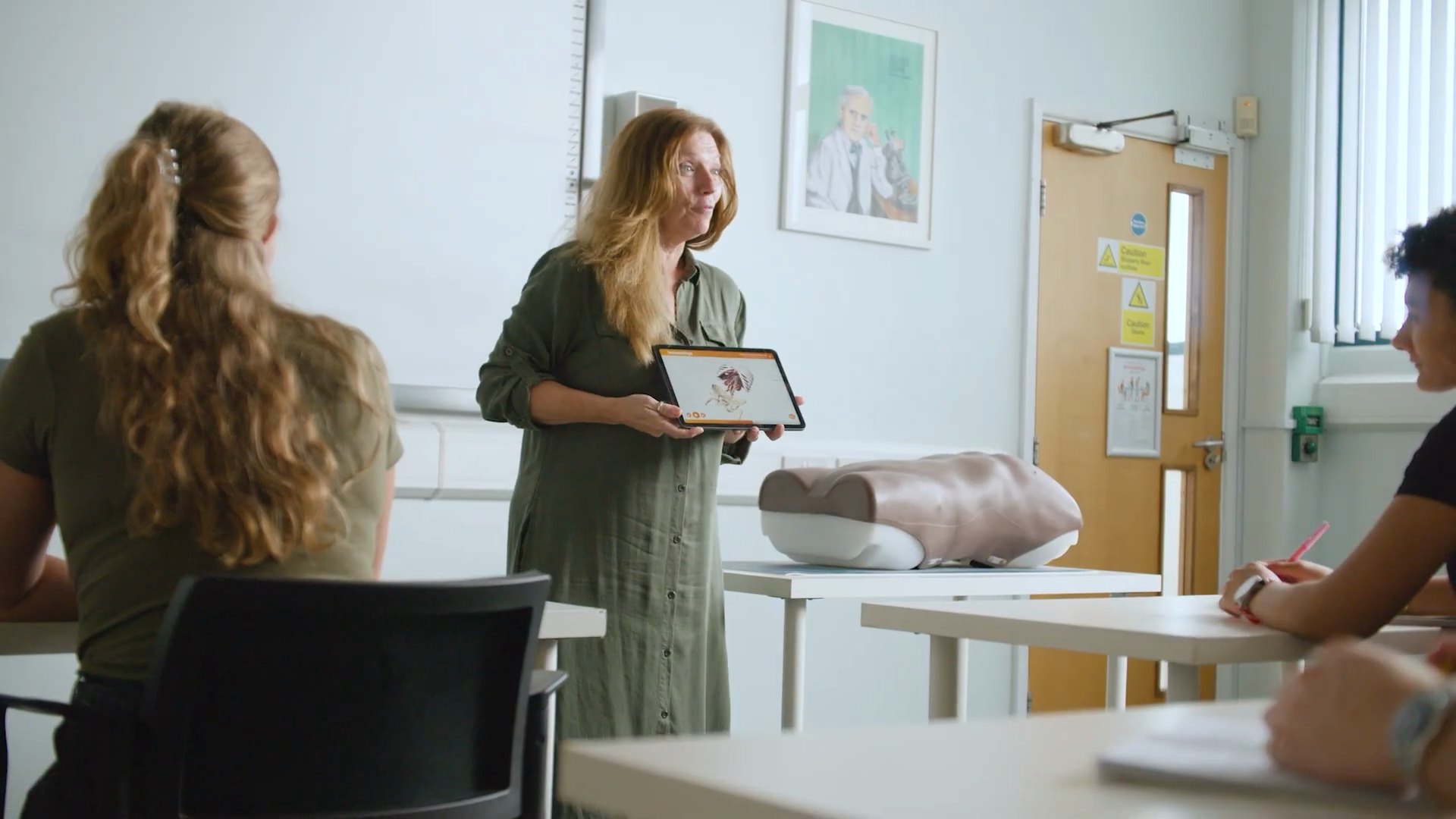 A tutor using the app with the Abdominal Examination Trainer in class